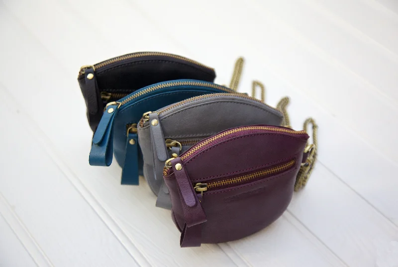 Handle bags with detachable pouches for versatility -Oval Clutch & Purse